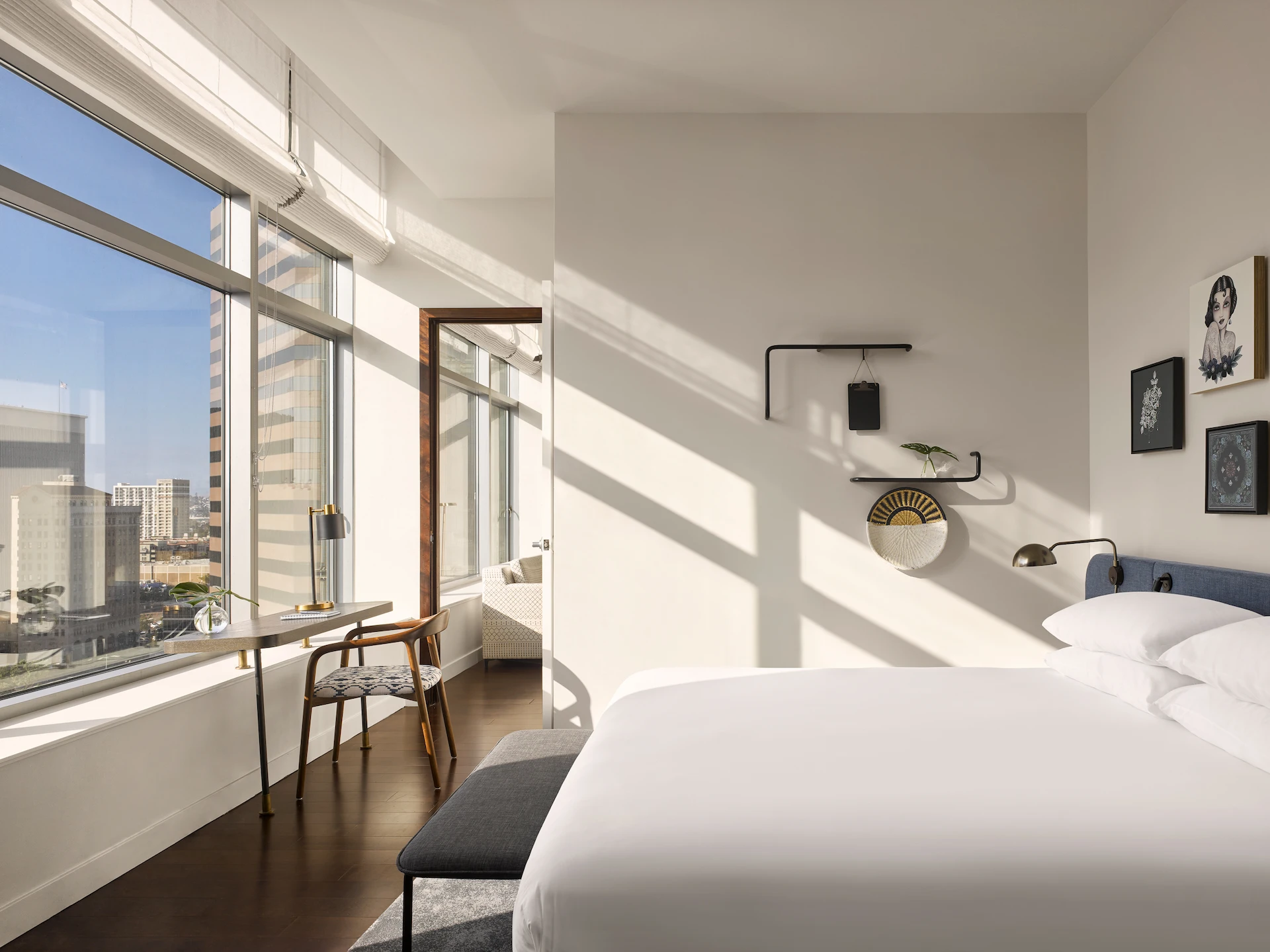 Bedroom with city views in the 1 Bedroom Suite, featuring stylish decor and a cozy atmospher